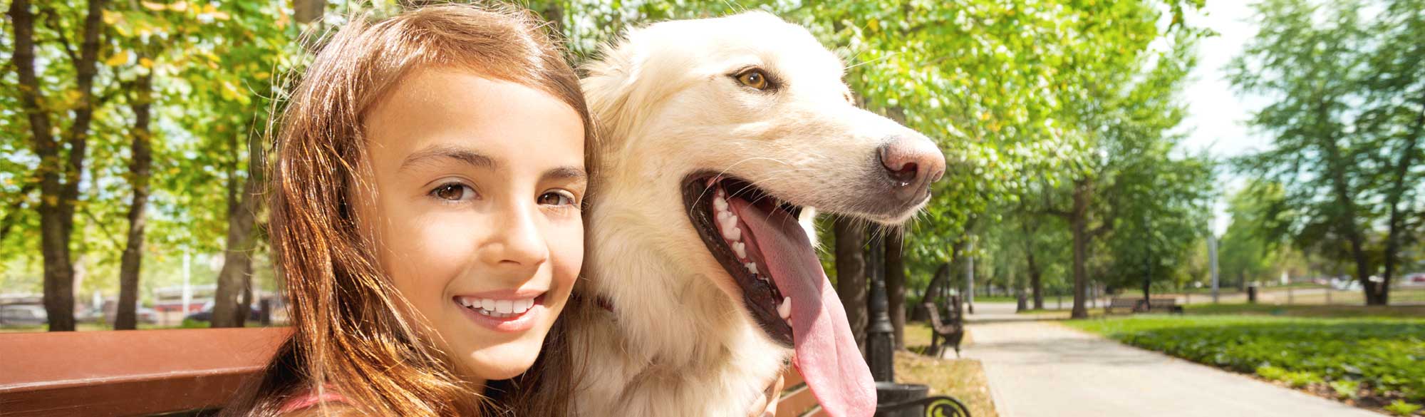 Girl smiling with her dog